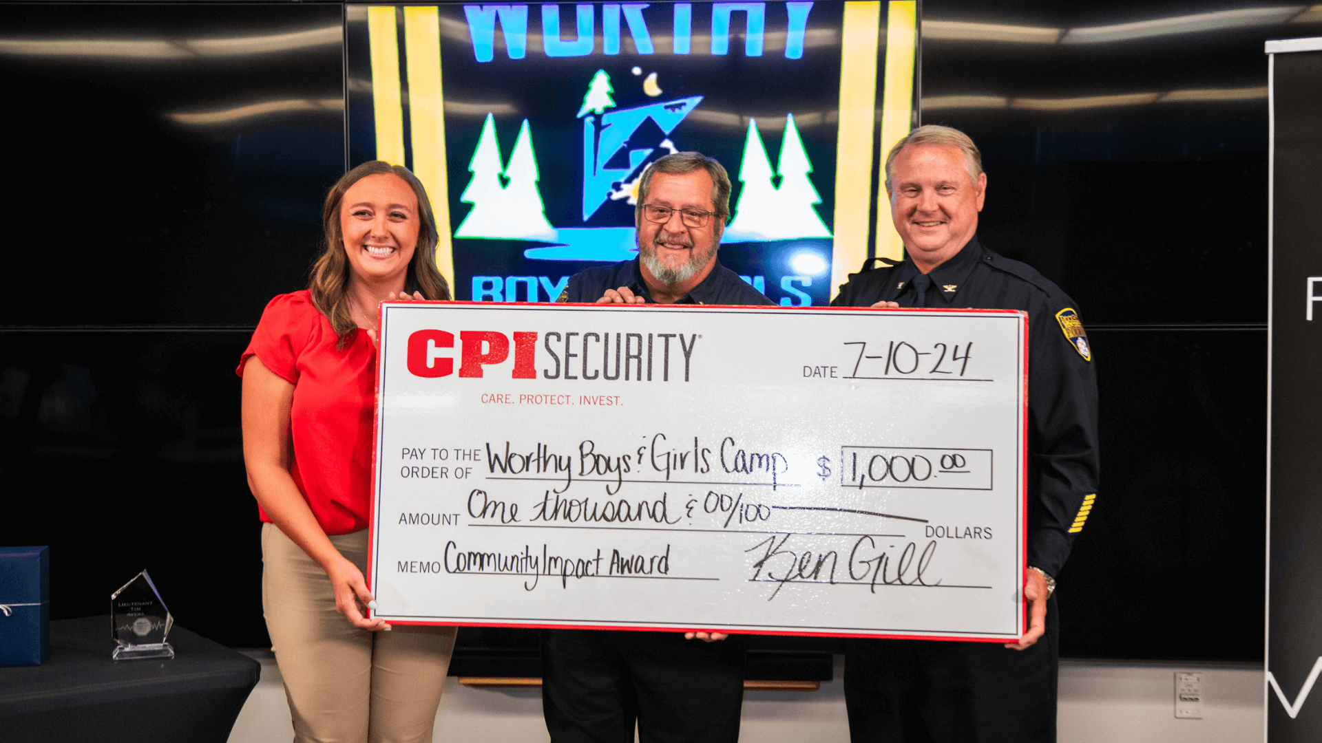 Three people holding check