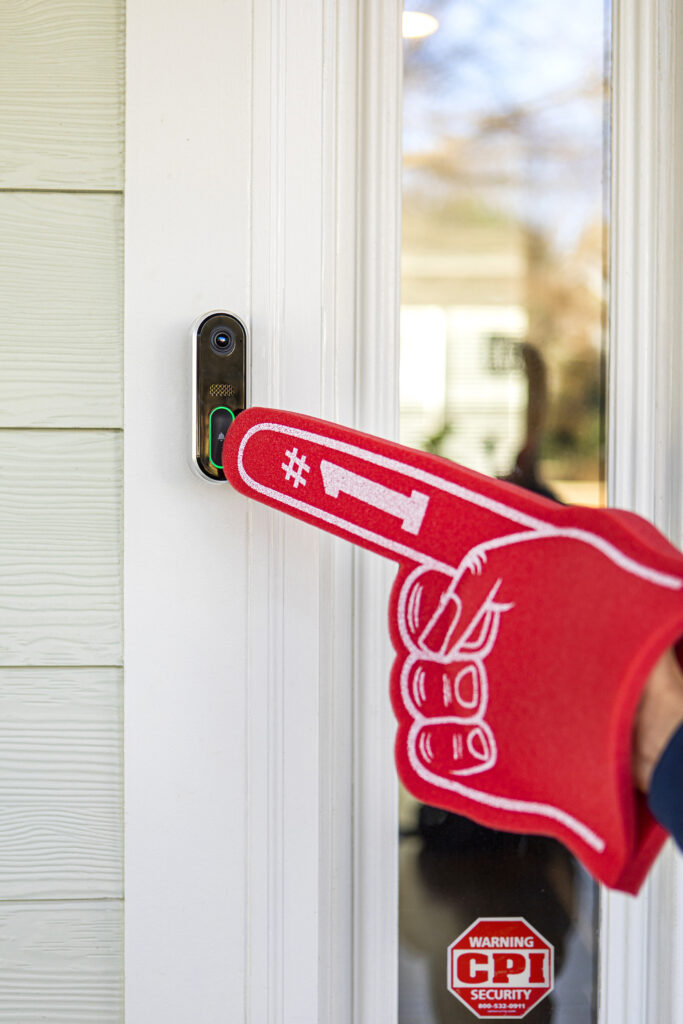 red foam finger ringing video doorbell