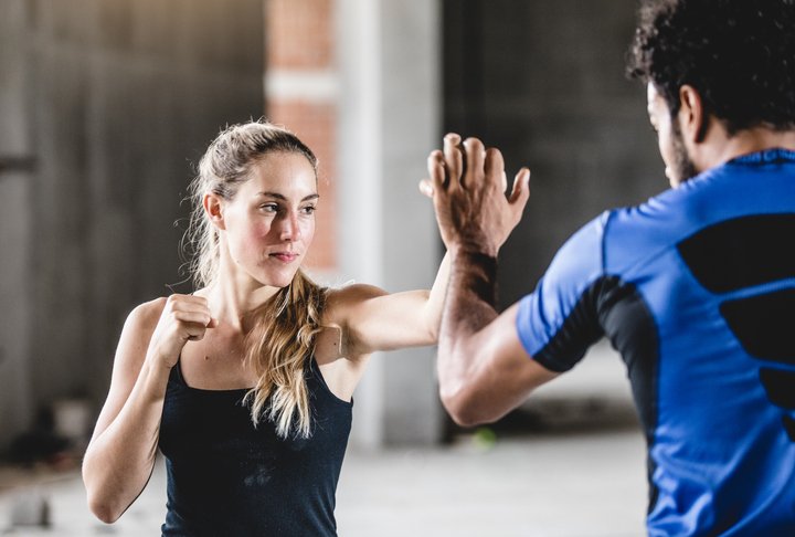 woman taking self defense class